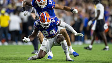 Oct 5, 2024; Gainesville, Florida, USA; Florida Gators defensive ends Tyreak Sapp (94) and T.J. Searcy (19) celebrate after a quarterback sack against the UCF Knights during the first half at Ben Hill Griffin Stadium. Mandatory Credit: Matt Pendleton-Imagn Images