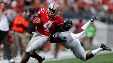 Ohio State Buckeyes running back Curtis Samuel (4) slips away from Kent State Golden Flashes safety Elcee Refuge (7) in the 4th quarter of a football game between The Ohio State University Buckeyes and the Kent State University Golden Flashes on Saturday, September 13, 2014 at Ohio Stadium in Columbus, Ohio. (Columbus Dispatch photo by Fred Squillante)