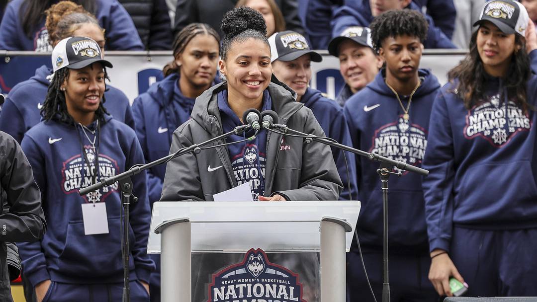 Apr 13, 2025; Hartford, CT, USA; UConn student-athlete Azzi Fudd addresses the crowd while her teammates UConn student-athletes Paige Bueckers, KK Arnold, Sarah Strong and Ayanna Patterson look on during the Final Four champions victory parade and rally outside of the XL Center in Hartford, CT. Mandatory Credit: Scott Rausenberger-Imagn Images Apr 13, 2025; Hartford, CT, USA; UConn student-athlete Azzi Fudd addresses the crowd while her teammates UConn student-athletes Paige Bueckers, KK Arnold, Sarah Strong and Ayanna Patterson look on during the Final Four champions victory parade and rally outside of the XL Center in Hartford, CT. Mandatory Credit: Scott Rausenberger-Imagn Images