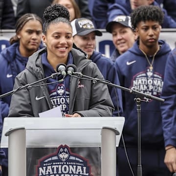 Apr 13, 2025; Hartford, CT, USA;   UConn student-athlete Azzi Fudd addresses the crowd while her teammates UConn student-athletes Paige Bueckers,  KK Arnold, Sarah Strong  and Ayanna Patterson look on during the Final Four champions victory parade and rally outside of the XL Center in Hartford, CT. Mandatory Credit: Scott Rausenberger-Imagn Images
