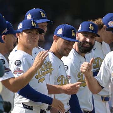 Mar 27, 2025; Los Angeles, California, USA; Los Angeles Dodgers outfielder Chris Taylor (3) reacts with teammates before the game against the Detroit Tigers at Dodger Stadium. Mandatory Credit: Jayne Kamin-Oncea-Imagn Images