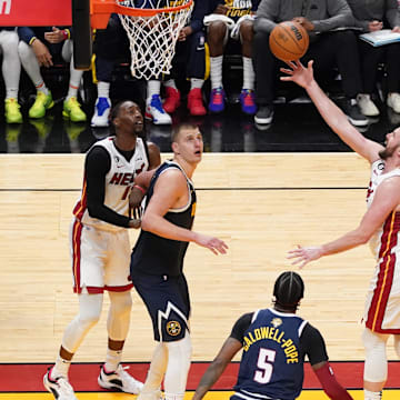 Miami Heat forward Kevin Love (42) shoots the ball over Denver Nuggets center Nikola Jokic (15) during the second half in game four of the 2023 NBA Finals at Kaseya Center. 