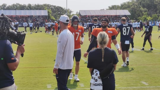 Caleb Williams and the quarterbacks go through stretching work prior to Friday's Bears practice, the first one in pads.