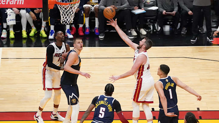 Miami Heat forward Kevin Love (42) shoots the ball over Denver Nuggets center Nikola Jokic (15) during the second half in game four of the 2023 NBA Finals at Kaseya Center. 