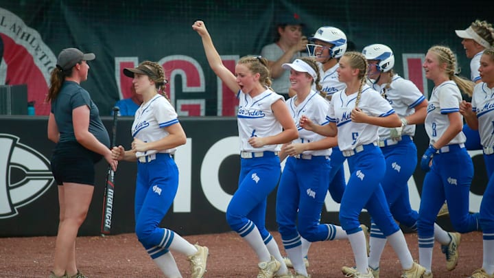 Members of the Van Meter softball team celebrate after Macy Blomgren hit a home run against Iowa City Reginain their Class 2A game on Tuesday, July 19, 2022, during the Iowa high school girls state softball tournament in Fort Dodge.

Statesb 20220719 Bh