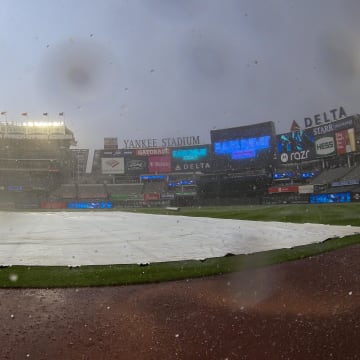 Sep 9, 2023; Bronx, New York, USA;  The tarp lays over the field during a rain delay prior to the start of the game between the Milwaukee Brewers and the New York Yankees at Yankee Stadium. Mandatory Credit: Wendell Cruz-USA TODAY Sports