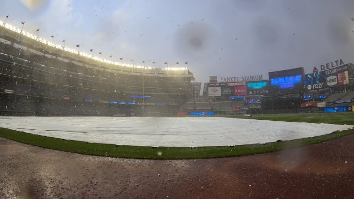 Sep 9, 2023; Bronx, New York, USA;  The tarp lays over the field during a rain delay prior to the start of the game between the Milwaukee Brewers and the New York Yankees at Yankee Stadium. Mandatory Credit: Wendell Cruz-USA TODAY Sports