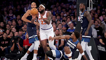 Nov 5, 2025; New York, New York, USA; New York Knicks center Mitchell Robinson (23) passes the ball against Minnesota Timberwolves center Rudy Gobert (27) and guard Anthony Edwards (5) and forward Julius Randle (30) during the first quarter at Madison Square Garden.
