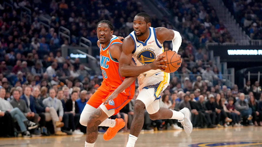 Warriors forward Jonathan Kuminga drives past Thunder guard Jalen Williams.