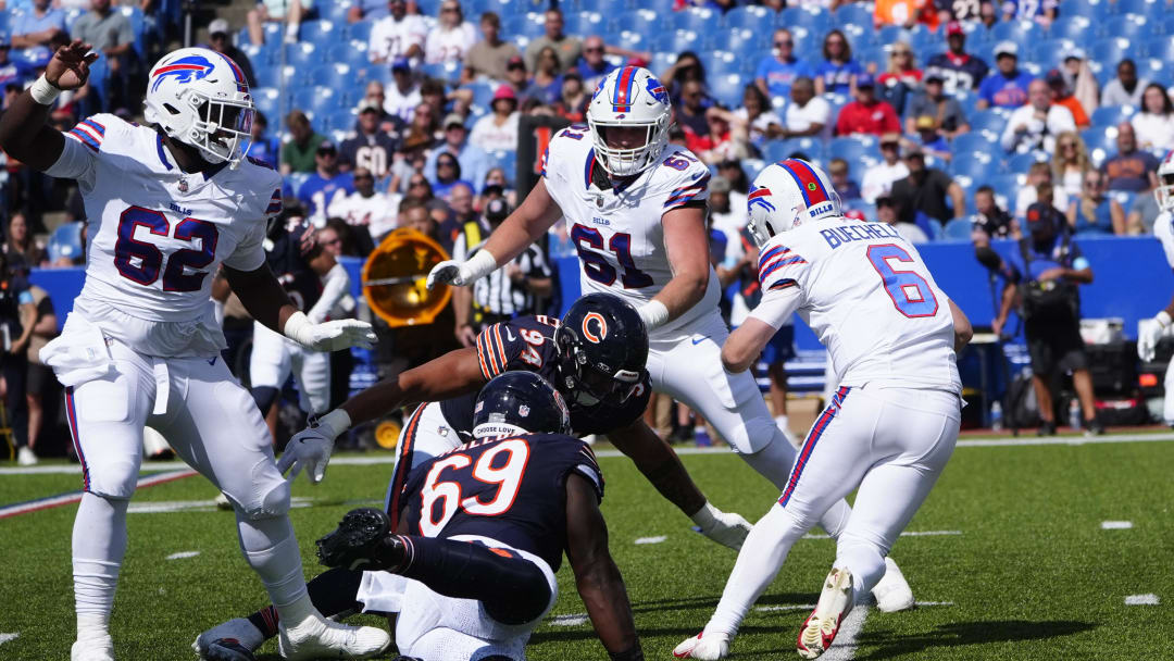 Aug 10, 2024; Orchard Park, New York, USA; Chicago Bears defensive end Austin Booker (94) tackles Buffalo Bills quarterback Shane Buechele (6) during the second half at Highmark Stadium. Mandatory Credit: Gregory Fisher-USA TODAY Sports