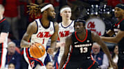 Jan 4, 2025; Oxford, Mississippi, USA; Mississippi Rebels forward Mikeal Brown-Jones (1) dribbles as Georgia Bulldogs forward Dylan James (13) defends during the first half at The Sandy and John Black Pavilion at Ole Miss. Mandatory Credit: Petre Thomas-Imagn Images