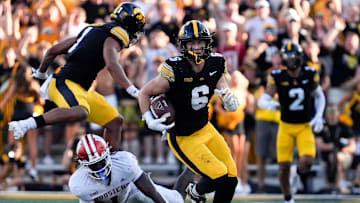 Iowa Hawkeyes defensive back Zach Lutmer (6) runs with the ball after intercepting a pass by Indiana Hoosiers quarterback Fernando Mendoza (15) Sept. 27, 2025 at Kinnick Stadium in Iowa City, Iowa.