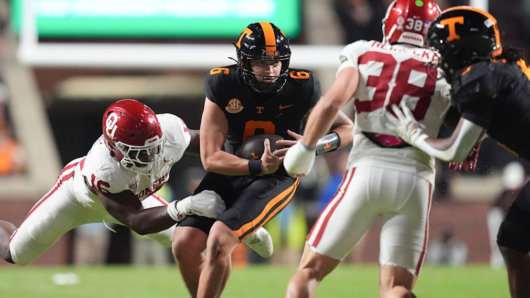 Tennessee quarterback Joey Aguilar (6) is grabbed by Oklahoma defensive lineman Danny Okoye (16) during an NCAA college football game on November 1, 2025, in Knoxville, Tenn.