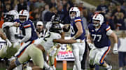 Nov 8, 2025; Charlottesville, Virginia, USA; Virginia Cavaliers quarterback Daniel Kaelin (10) is sacked by Wake Forest Demon Deacons defensive lineman Dallas Afalava (52) to fumble the ball for an overturn during the first half at Scott Stadium. Mandatory Credit: Amber Searls-Imagn Images