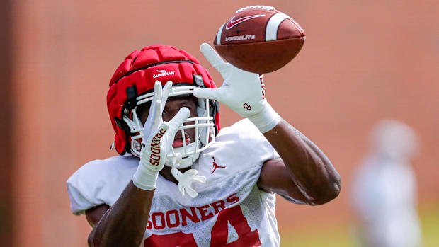Samuel Omosigho (24) runs drills during an OU football practice in Norman, Okla., on Monday, Aug. 7, 2023.