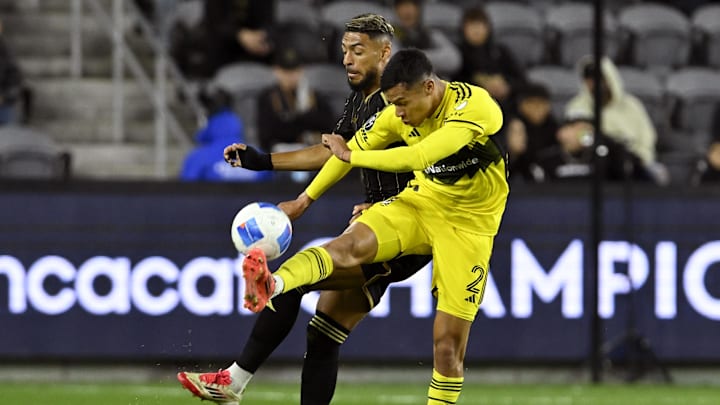 Mar 4, 2025; Los Angeles, California, USA; Columbus Crew defender Marcelo Herrera (2) gets to the ball before Los Angeles FC forward Denis Bouanga (99) during the first half at BMO Stadium. Mandatory Credit: Alex Gallardo-Imagn Images