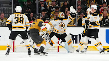 Mar 20, 2025; Las Vegas, Nevada, USA; Boston Bruins goaltender Jeremy Swayman (1) reaches to catch a loose puck in front of Vegas Golden Knights left wing Pavel Dorofeyev (16) during the first period at T-Mobile Arena. Mandatory Credit: Stephen R. Sylvanie-Imagn Images