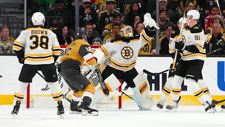 Mar 20, 2025; Las Vegas, Nevada, USA; Boston Bruins goaltender Jeremy Swayman (1) reaches to catch a loose puck in front of Vegas Golden Knights left wing Pavel Dorofeyev (16) during the first period at T-Mobile Arena. Mandatory Credit: Stephen R. Sylvanie-Imagn Images