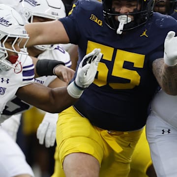 Nov 23, 2024; Ann Arbor, Michigan, USA;  Northwestern Wildcats running back Cam Porter (1) runs the ball against the Michigan Wolverines in the first half at Michigan Stadium. Mandatory Credit: Rick Osentoski-Imagn Images