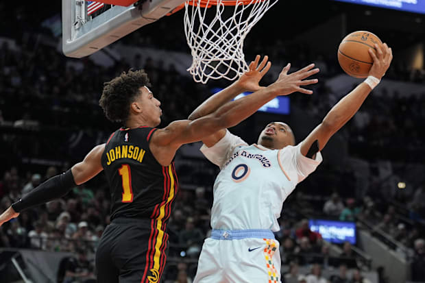 Dec 19, 2024; San Antonio, Texas, USA;  San Antonio Spurs forward Keldon Johnson (0) shoots against Atlanta Hawks forward Jal