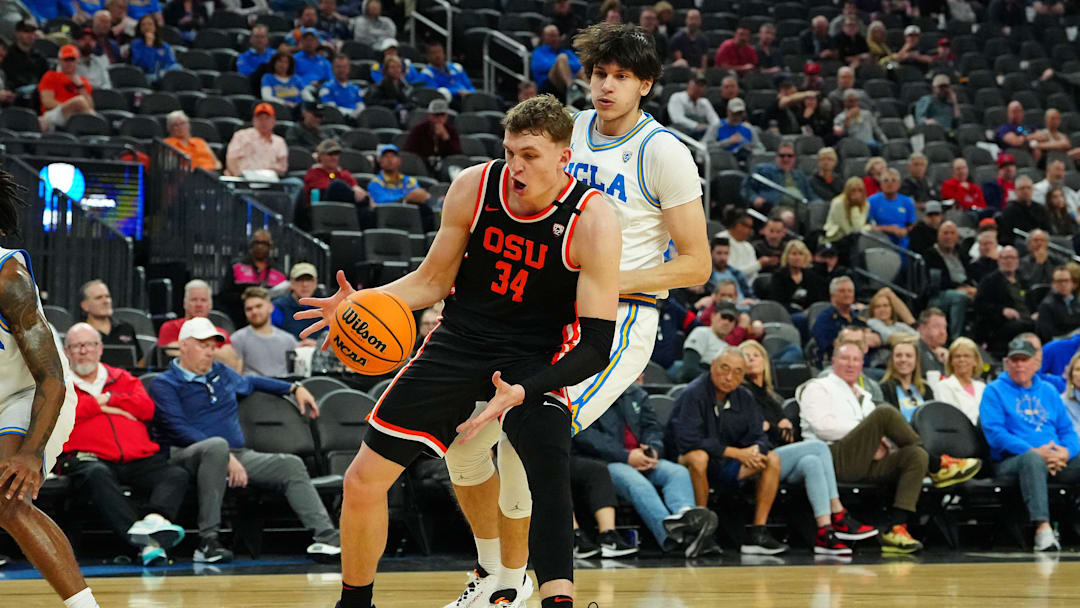 Mar 13, 2024; Las Vegas, NV, USA; Oregon State Beavers forward Tyler Bilodeau (34) takes a pass in front of UCLA Bruins forward Berke Buyuktuncel (9) during the second half at T-Mobile Arena. Mandatory Credit: Stephen R. Sylvanie-Imagn Images