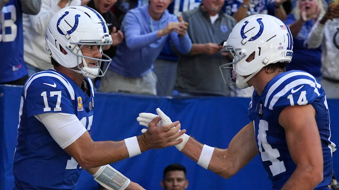 Oct 12, 2025; Indianapolis, Indiana, USA; Indianapolis Colts quarterback Daniel Jones (17) celebrates with wide receiver Alec Pierce (14) after Jones scores a touchdown during a game against the Arizona Cardinals at Lucas Oil Stadium. Mandatory Credit: Christine Tannous-USA TODAY Network via Imagn Images