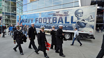 Dec 9, 2023; Foxborough, Massachusetts, USA; Members of the US Navy walk by the Navy football team equipment truck at the Army-Navy Game Fan Experience at Gillette Stadium. 