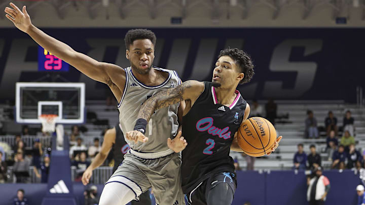 Jan 24, 2024; Houston, Texas, USA; Florida Atlantic Owls guard Nick Boyd (2) drives with the ball as Rice Owls guard Noah Shelby (1) defends during the first half at Tudor Fieldhouse. Mandatory Credit: Troy Taormina-Imagn Images