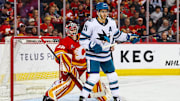 Apr 13, 2025; Calgary, Alberta, CAN; San Jose Sharks center Alexander Wennberg (21) screens in front of Calgary Flames goaltender Dustin Wolf (32) during the third period at Scotiabank Saddledome. Mandatory Credit: Sergei Belski-Imagn Images