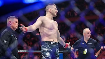 Nov 12, 2022; New York, NY, USA; Dan Hooker (red gloves) defeats Claudio Puelles (blue gloves) during UFC 281 at Madison Square Garden. Mandatory Credit: Jessica Alcheh-Imagn Images