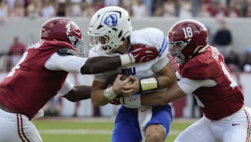 Nov 22, 2025; Tuscaloosa, Alabama, USA;  Eastern Illinois quarterback Cole LaCrue (3) is tackled by Alabama linebacker Qua Russaw (4) and Alabama defensive back Bray Hubbard (18) at Saban Field at Bryant-Denny Stadium. Mandatory Credit: Gary Cosby Jr.-Imagn Images