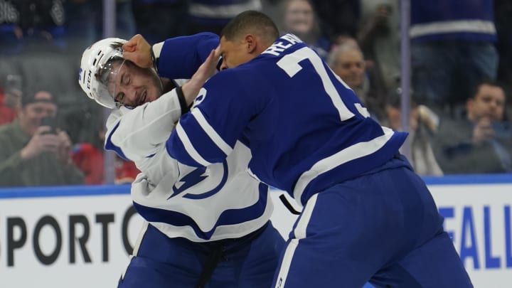 Apr 3, 2024; Toronto, Ontario, CAN; Toronto Maple Leafs forward Ryan Reaves (75) lands a punch on Tampa Bay Lightning forward Tanner Jeannot (84) during a fight in the third period at Scotiabank Arena. Mandatory Credit: John E. Sokolowski-USA TODAY Sports