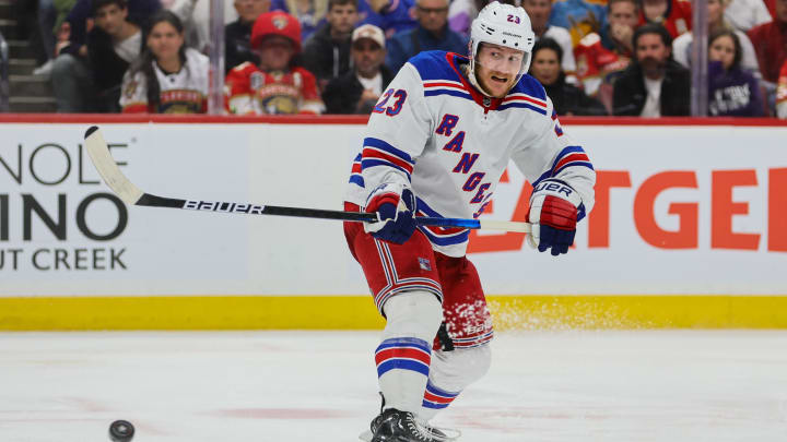 May 28, 2024; Sunrise, Florida, USA; New York Rangers defenseman Adam Fox (23) shoots the puck against the Florida Panthers during the third period in game four of the Eastern Conference Final of the 2024 Stanley Cup Playoffs at Amerant Bank Arena. Mandatory Credit: Sam Navarro-USA TODAY Sports