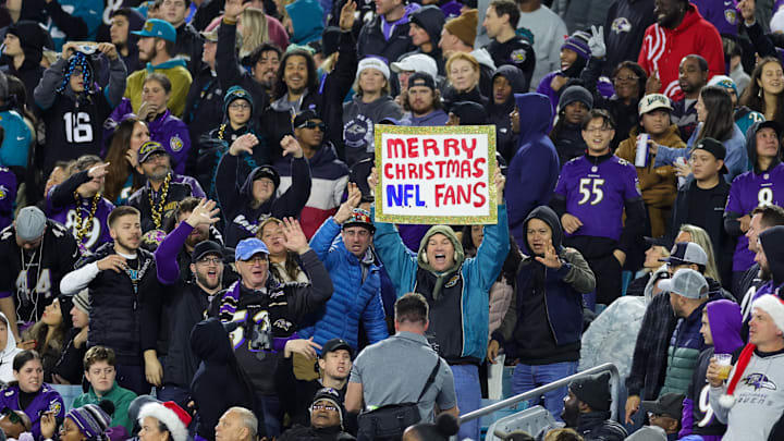 fans watch with a Merry Christmas sign during a game between the Baltimore Ravens and Jacksonville Jaguars 
