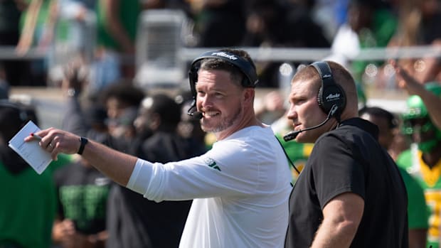 Oregon Coach Dan Lanning, left, and Defensive Coordinator Tosh Lupoi discus their game plan against Oklahoma Stat
