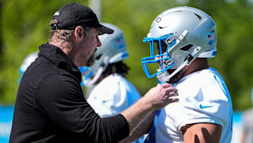 Detroit Lions head coach Dan Campbell talks to defensive lineman Breiden Fehoko (76) during rookie mini camp at Meijer Performance Center in Allen Park on Friday, May 9, 2025.