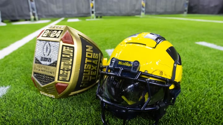 Jan 8, 2024; Houston, TX, USA; Detailed view of a Michigan Wolverines helmet and an oversized championship ring after defeating the Washington Huskies during the 2024 College Football Playoff national championship game at NRG Stadium. Mandatory Credit: Mark J. Rebilas-USA TODAY Sports