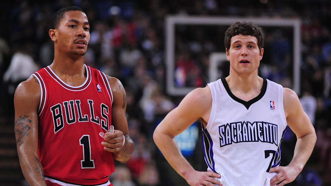 December 29, 2011; Sacramento, CA, USA; Chicago Bulls point guard Derrick Rose (1) and Sacramento Kings guard Jimmer Fredette (7) rest between plays during the fourth quarter at Power Balance Pavilion. The Bulls defeated the Kings 108-98. Mandatory Credit: Kyle Terada-Imagn Images