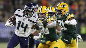 Jan 12, 2020; Green Bay, WI, USA; Seattle Seahawks wide receiver D.K. Metcalf (14) tries to get away from Green Bay Packers strong safety Adrian Amos (31)  in the third quarter of a NFC Divisional Round playoff football game at Lambeau Field. Mandatory Credit: Jeff Hanisch-Imagn Images