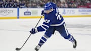 Oct 24, 2024; Toronto, Ontario, CAN; Toronto Maple Leafs defenseman Jake McCabe (22) shoots the puck against the St. Louis Blues during the third period at Scotiabank Arena. Mandatory Credit: John E. Sokolowski-Imagn Images