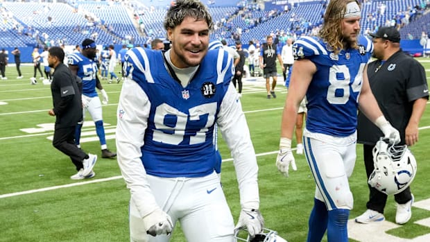 Colts defensive end Laiatu Latu (blue and white uniform) celebrates after securing a victory at home.