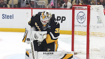Mar 18, 2025; Pittsburgh, Pennsylvania, USA;  Pittsburgh Penguins goaltender Tristan Jarry (35) makes a save against the New York Islanders during the second period at PPG Paints Arena. Mandatory Credit: Charles LeClaire-Imagn Images