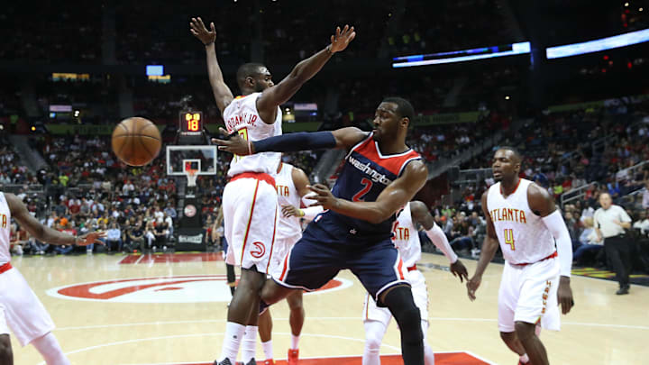 Apr 28, 2017; Atlanta, GA, USA; Washington Wizards guard John Wall (2) passes away from the defense of Atlanta Hawks guard Tim Hardaway Jr. (10) and forward Paul Millsap (4) in the first quarter in game six of the first round of the 2017 NBA Playoffs at Philips Arena. Mandatory Credit: Jason Getz-Imagn Images
