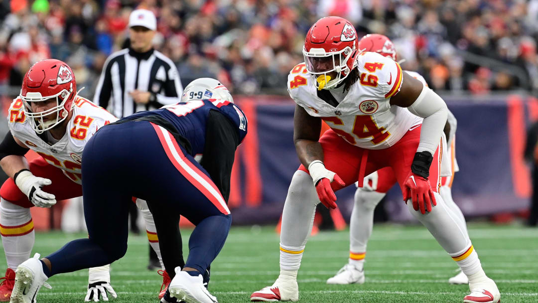 Dec 17, 2023; Foxborough, Massachusetts, USA; Kansas City Chiefs offensive tackle Wanya Morris (64) lines up against New England Patriots defensive end Keion White (99) during the first half at Gillette Stadium. Mandatory Credit: Eric Canha-USA TODAY Sports