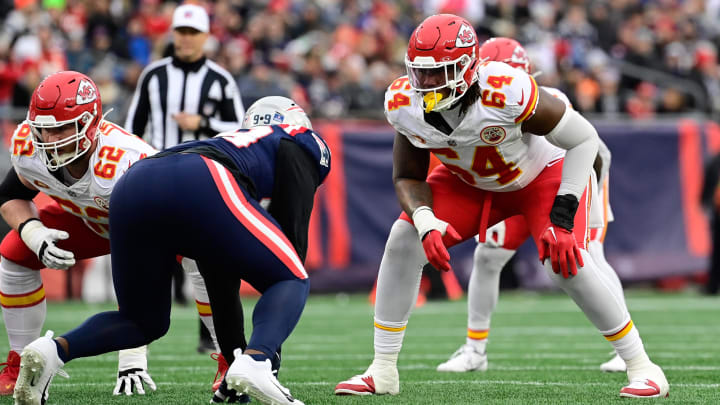 Dec 17, 2023; Foxborough, Massachusetts, USA; Kansas City Chiefs offensive tackle Wanya Morris (64) lines up against New England Patriots defensive end Keion White (99) during the first half at Gillette Stadium. Mandatory Credit: Eric Canha-USA TODAY Sports