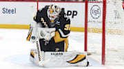 Mar 18, 2025; Pittsburgh, Pennsylvania, USA;  Pittsburgh Penguins goaltender Tristan Jarry (35) makes a save against the New York Islanders during the second period at PPG Paints Arena. Mandatory Credit: Charles LeClaire-Imagn Images