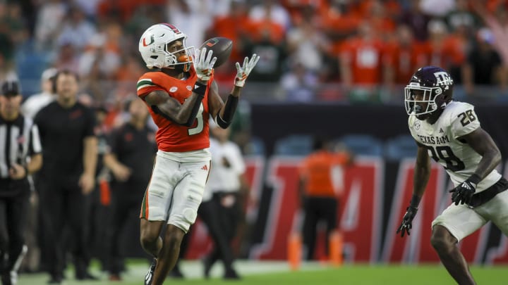 Sep 9, 2023; Miami Gardens, Florida, USA; Miami Hurricanes wide receiver Jacolby George (3) catches the football for a touchdown ahead of Texas A&M Aggies defensive back Josh DeBerry (28) during the fourth quarter at Hard Rock Stadium. Mandatory Credit: Sam Navarro-USA TODAY Sports