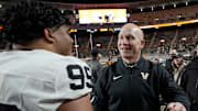 Vanderbilt coach Clark Lea celebrates with defensive lineman Joshua Singh (99) after defeating Tennessee at Neyland Stadium in Knoxville, Tenn., Saturday, Nov. 29, 2025.