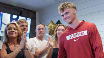 Dunlap senior and four-star college football recruit Mack Sutter, right, stands with his family after announcing his commitment to play football at the University of Alabama during a gathering Thursday, June 26, 2025 at Weaver's Fresh Food & Drink in Peoria.