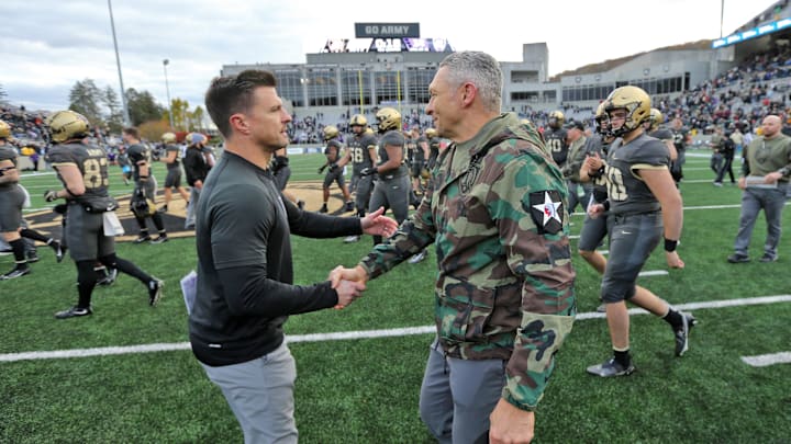 Nov 11, 2023; West Point, New York, USA; Army Black Knights head coach Jeff Monken greets Holy Cross Crusaders head coach Bob Chesney after as 17-14 win at Michie Stadium. Mandatory Credit: Danny Wild-Imagn Images